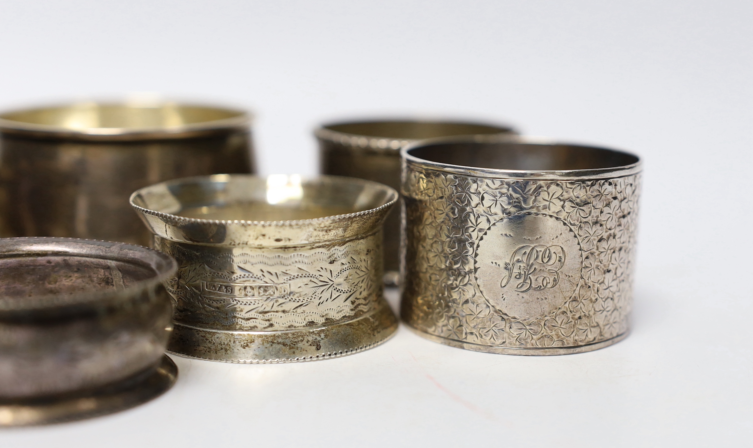 Seven assorted silver napkin rings and a small silver bowl